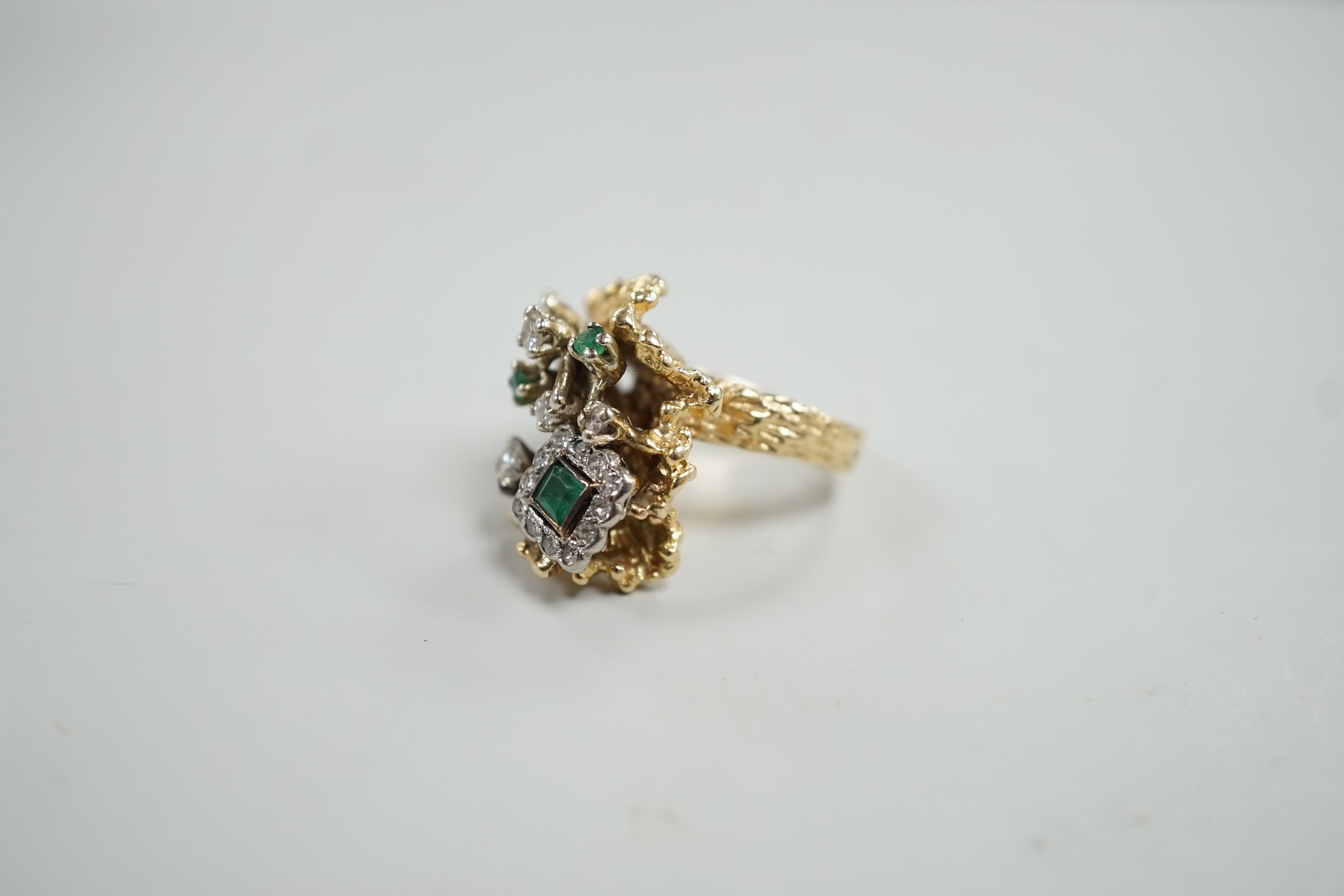 A modern 14k, emerald and diamond cluster set modernist dress ring, size L, gross weight 13.4 grams.